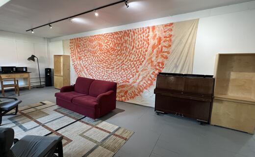 Artists lounge with leather couches and piano