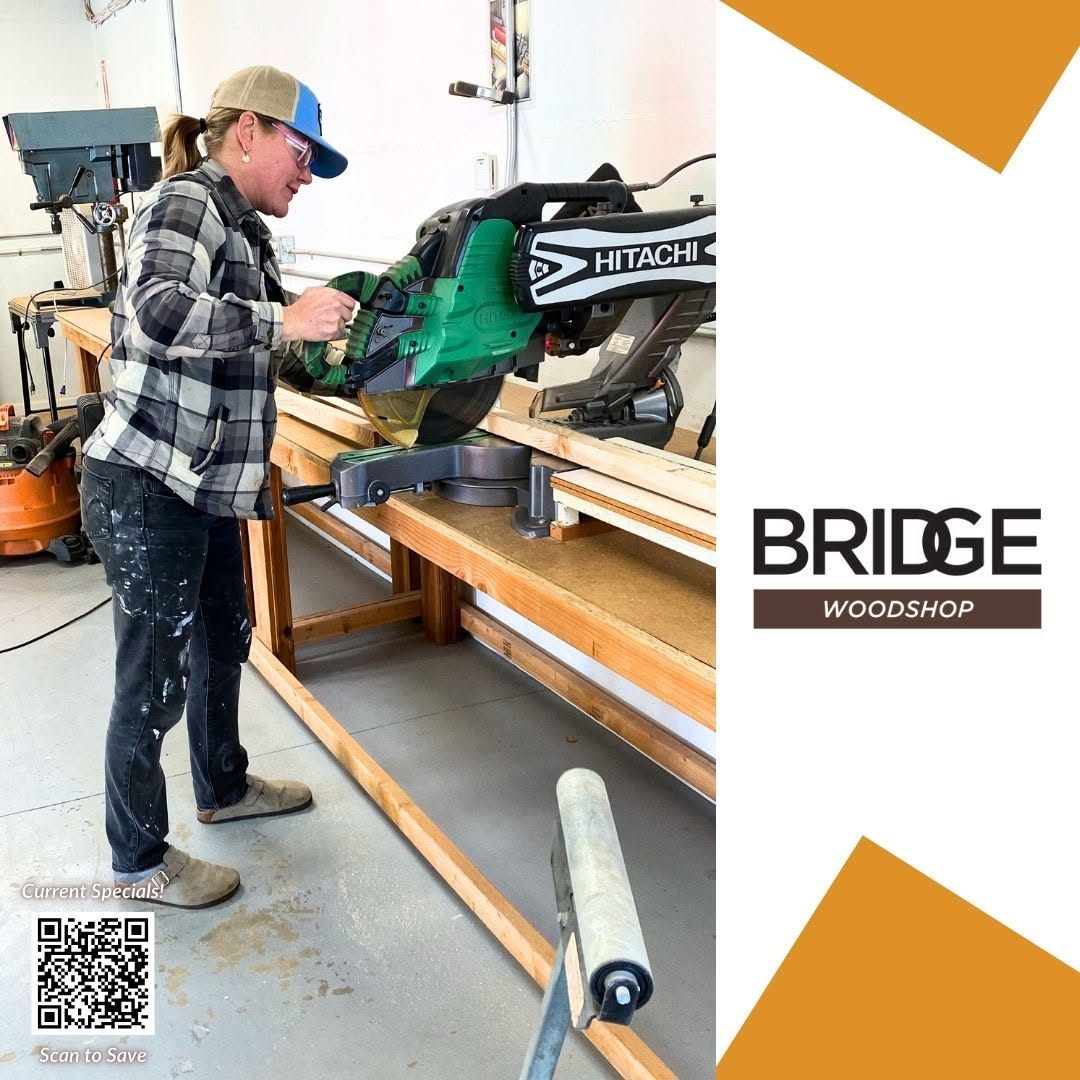 Woman using miter saw in woodshop